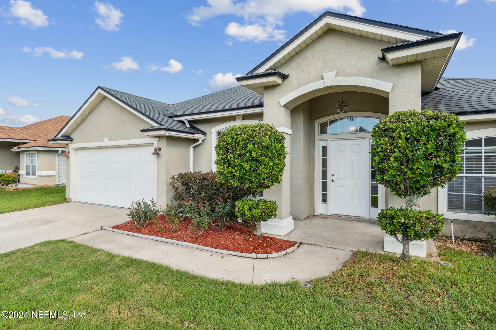 a front view of a house with a yard