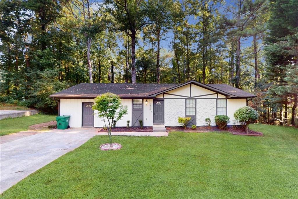 a view of a house with a yard porch and sitting area