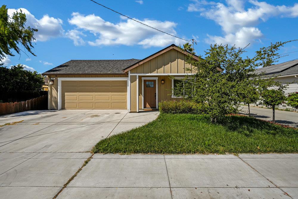 a front view of a house with a garden