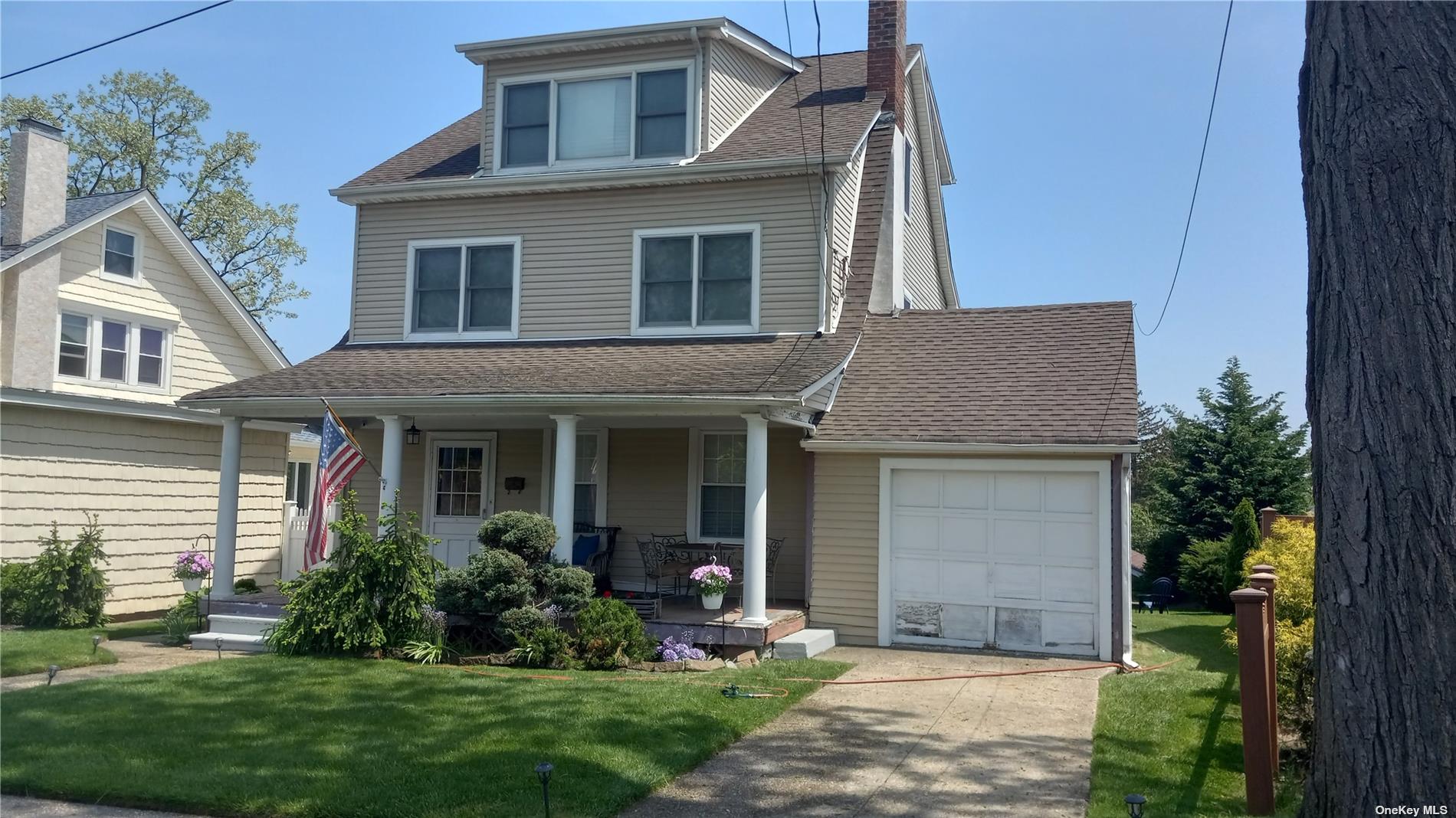 a front view of a house with a yard and porch