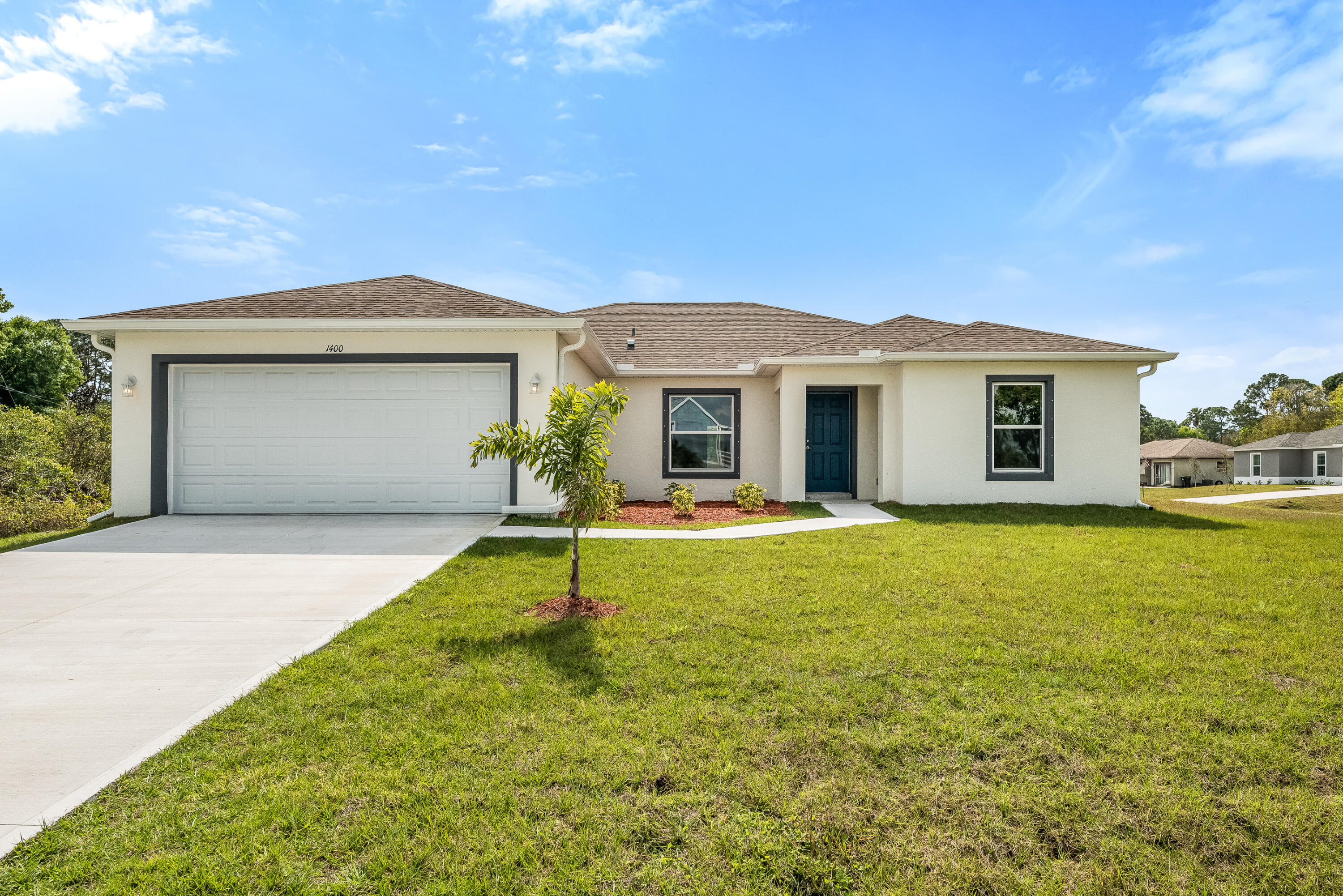 a front view of house with yard and outdoor seating