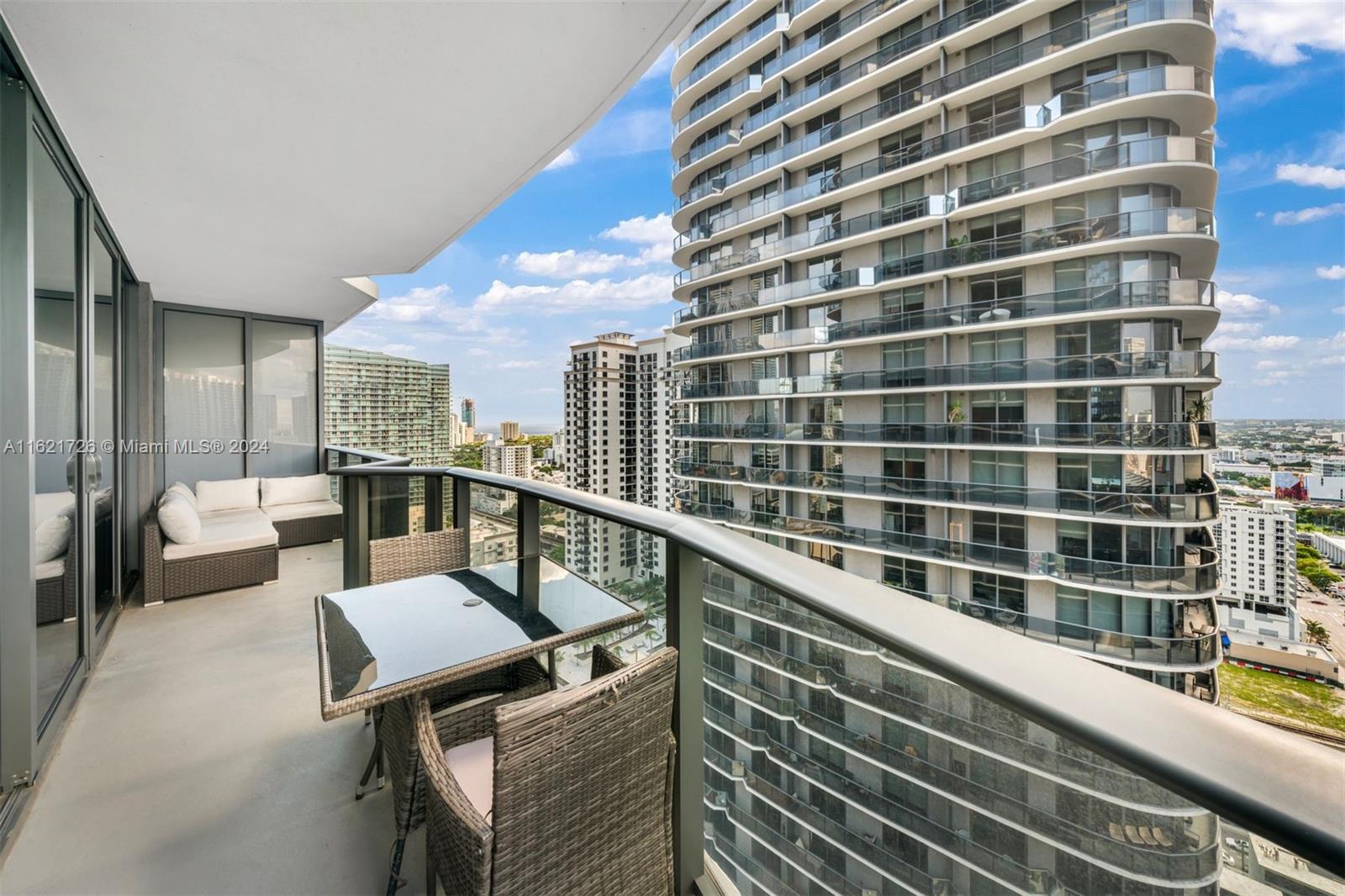 a view of a balcony with couch and wooden floor