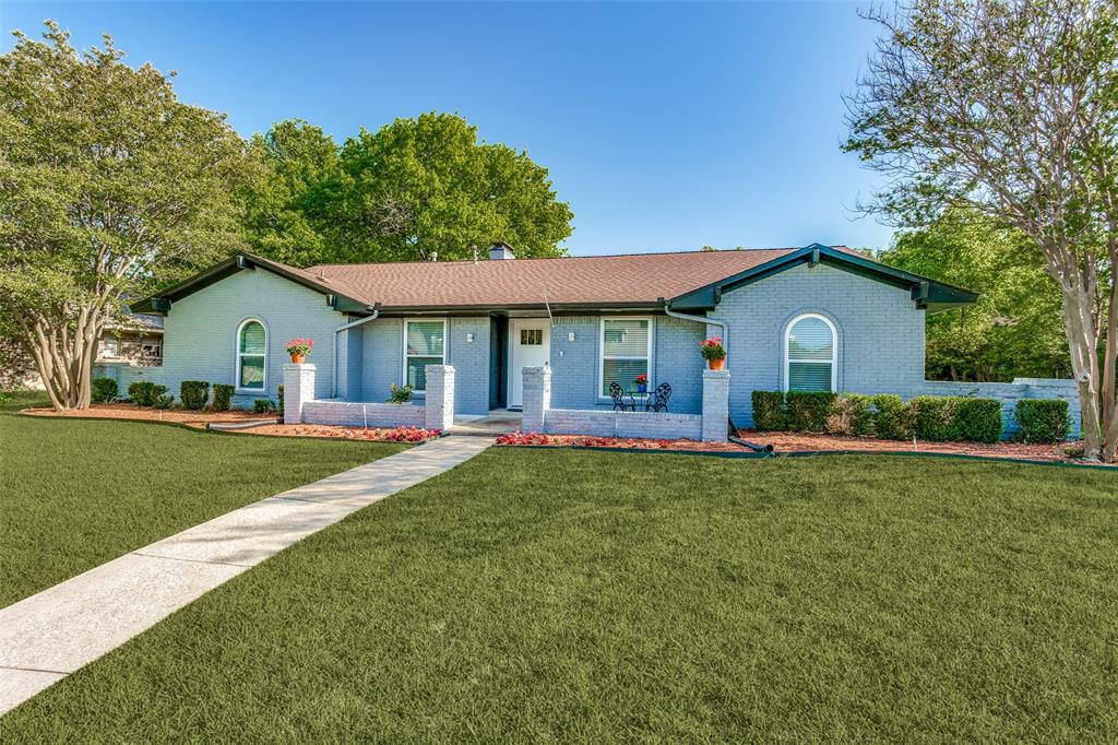 a front view of house with yard and outdoor seating