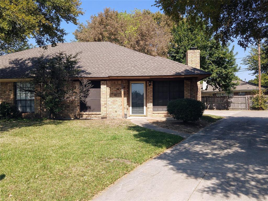 a front view of a house with a yard and trees