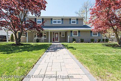 a front view of a house with yard and green space