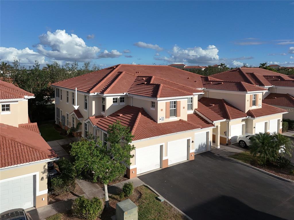 an aerial view of residential houses with cars