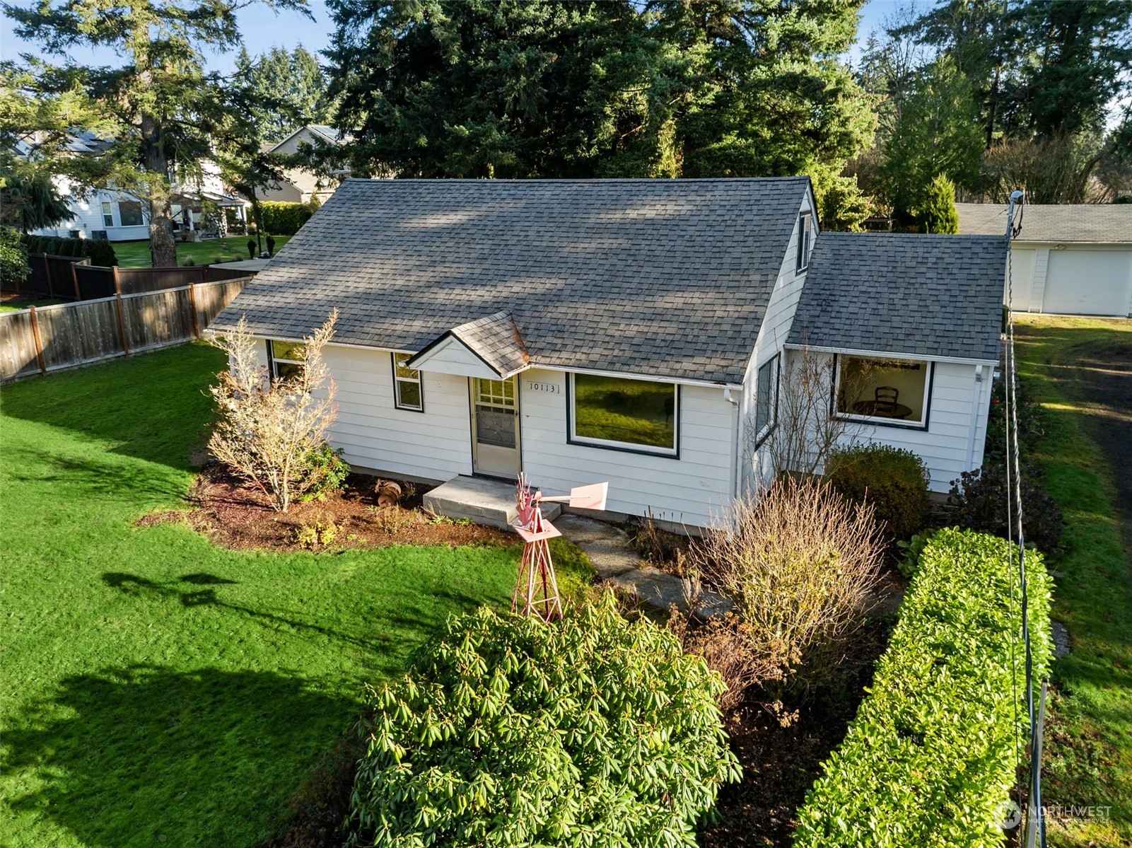 aerial view of a house with a yard and potted plants