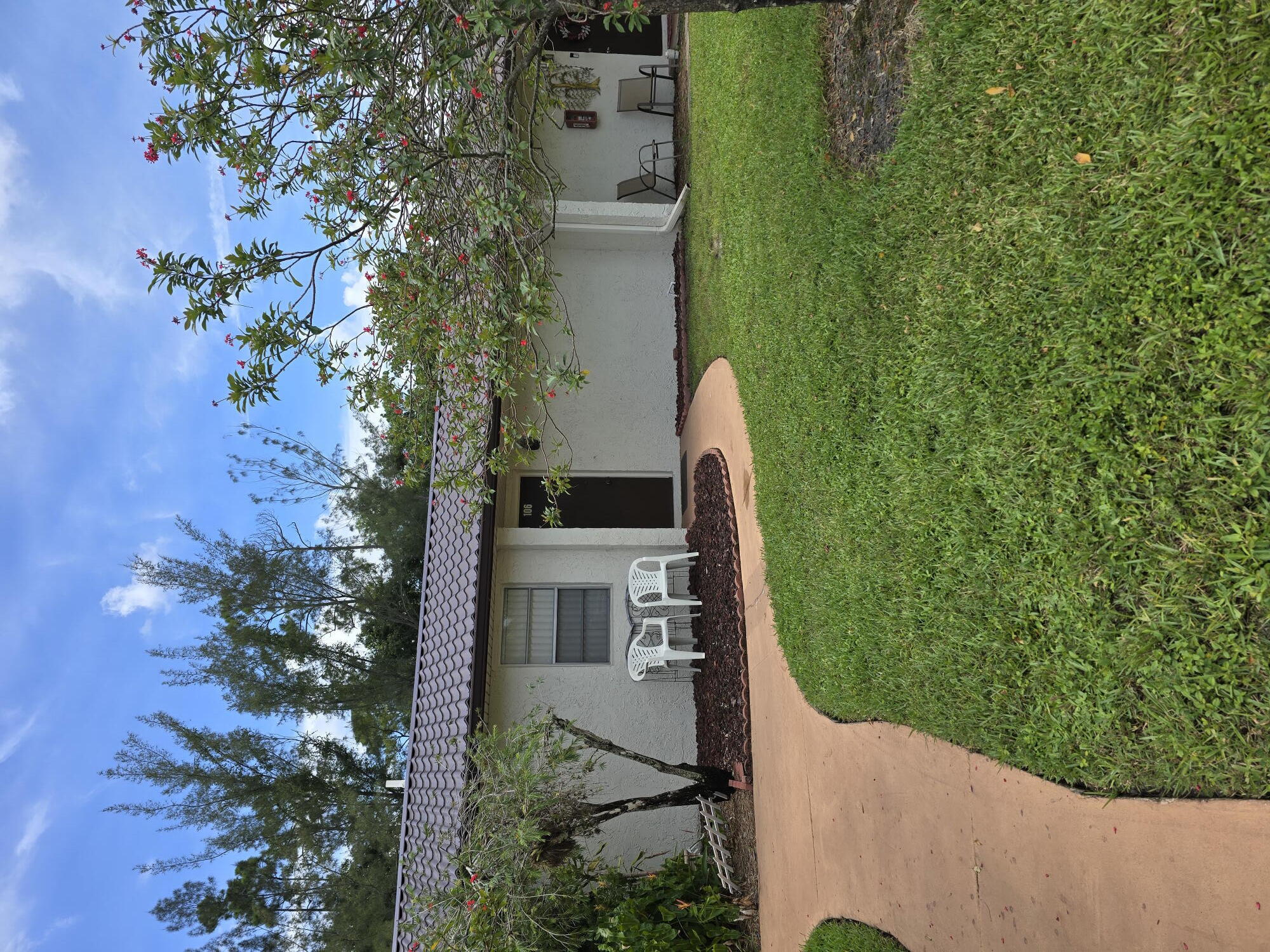 a view of a house with a garden and a yard