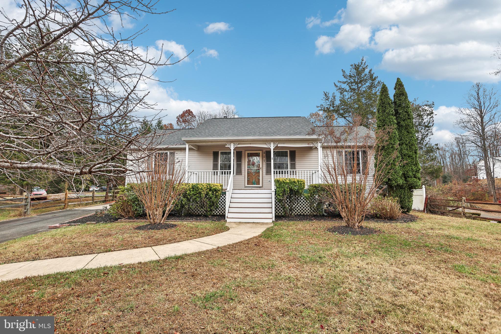 a front view of a house with a garden and patio