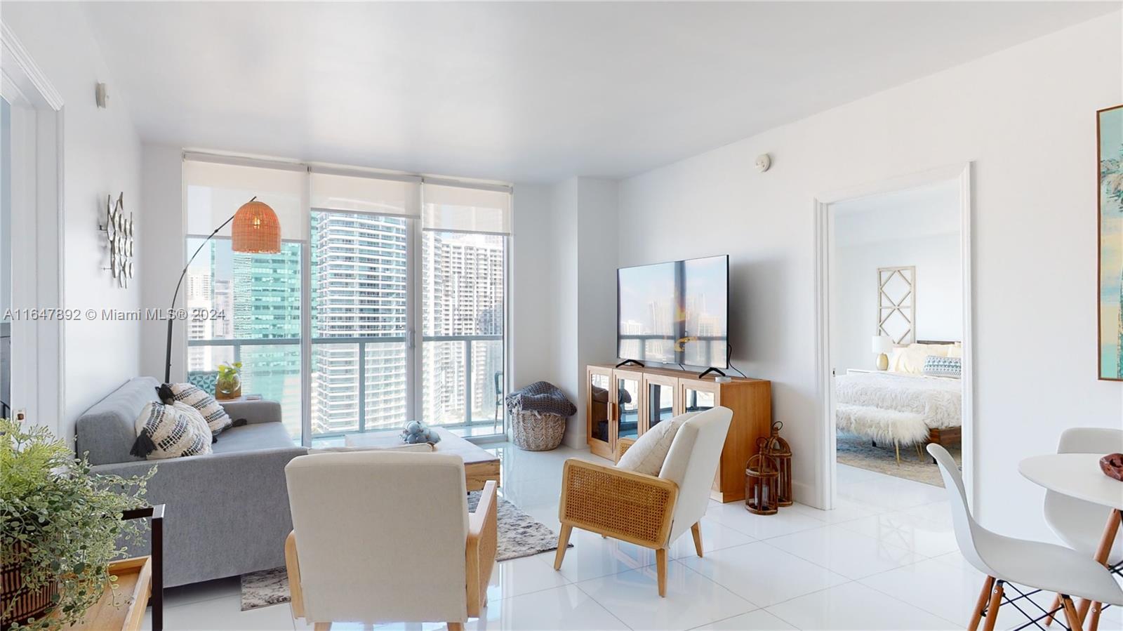 a living room with furniture and large windows