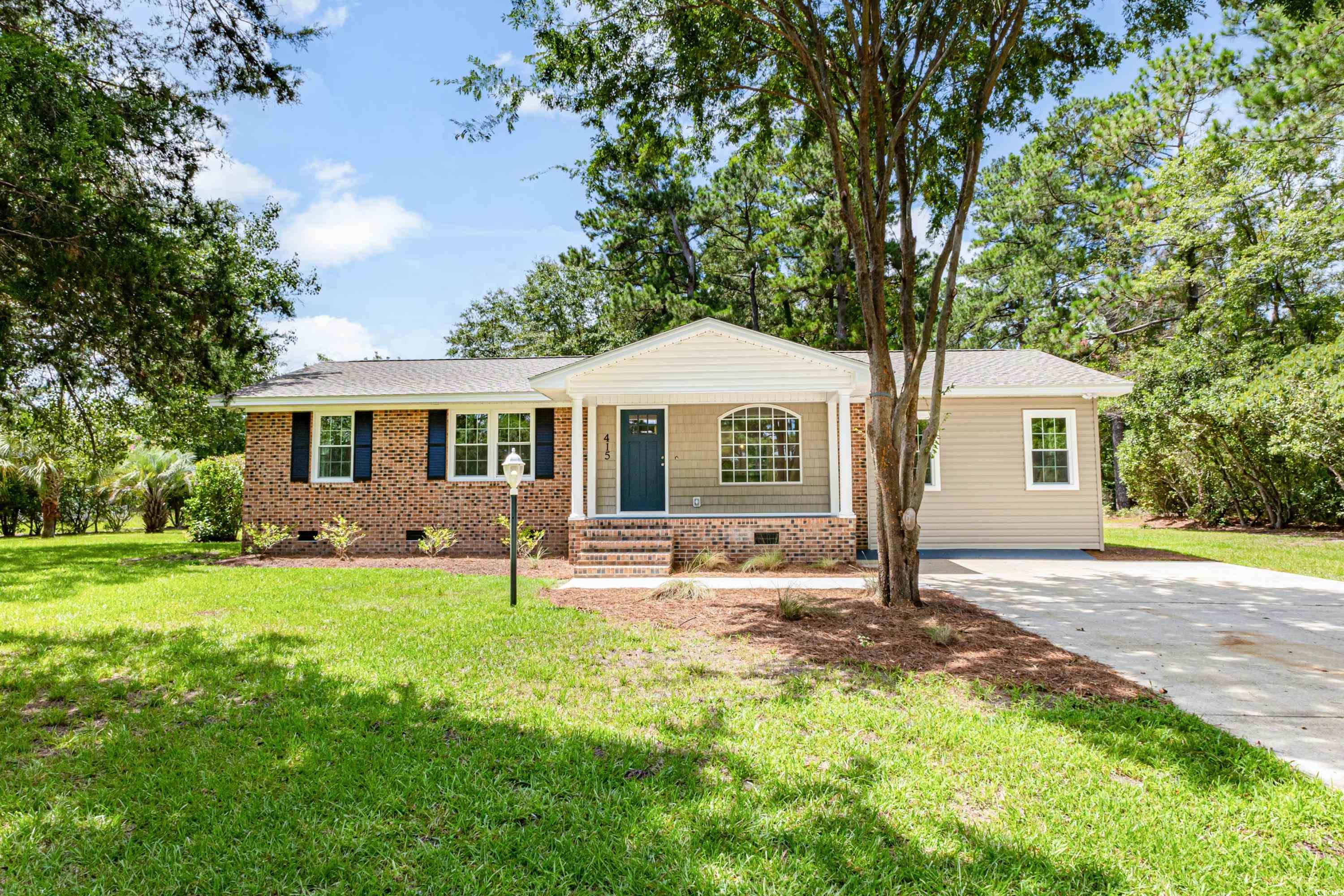 Single story home with a front yard