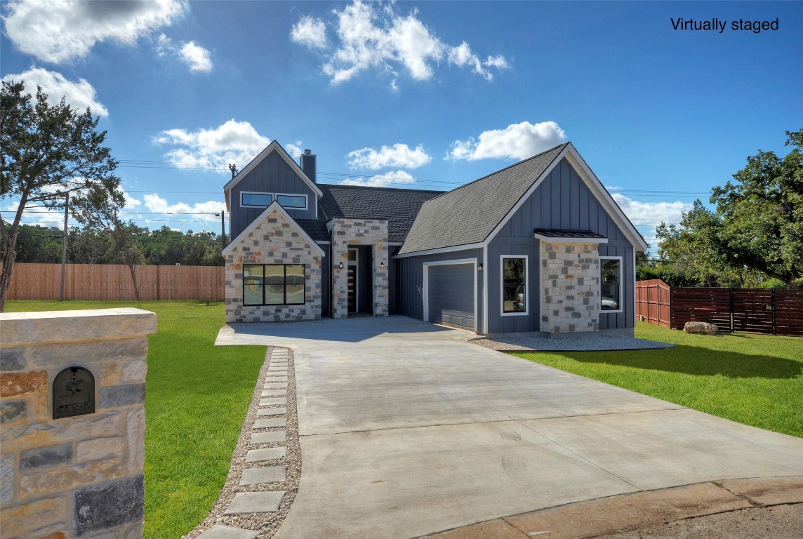 a front view of a house with yard and green space