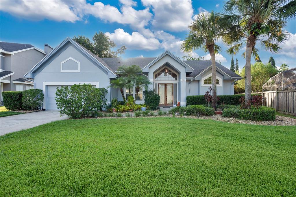 a front view of a house with a yard and garage