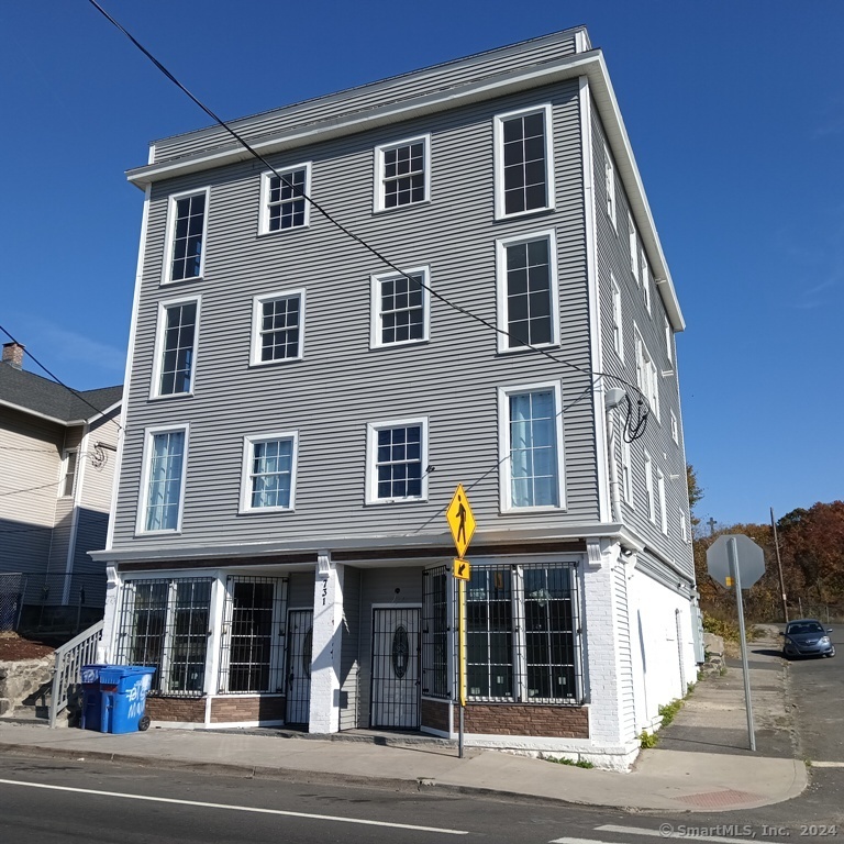 a front view of a residential apartment building with a yard