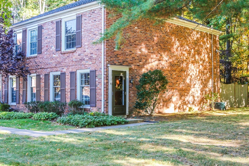 a view of a brick house with a yard