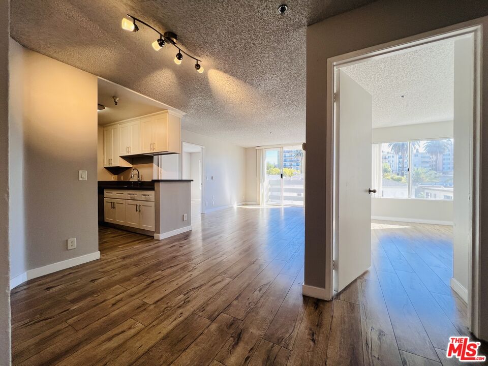 a view of a hallway with wooden floor