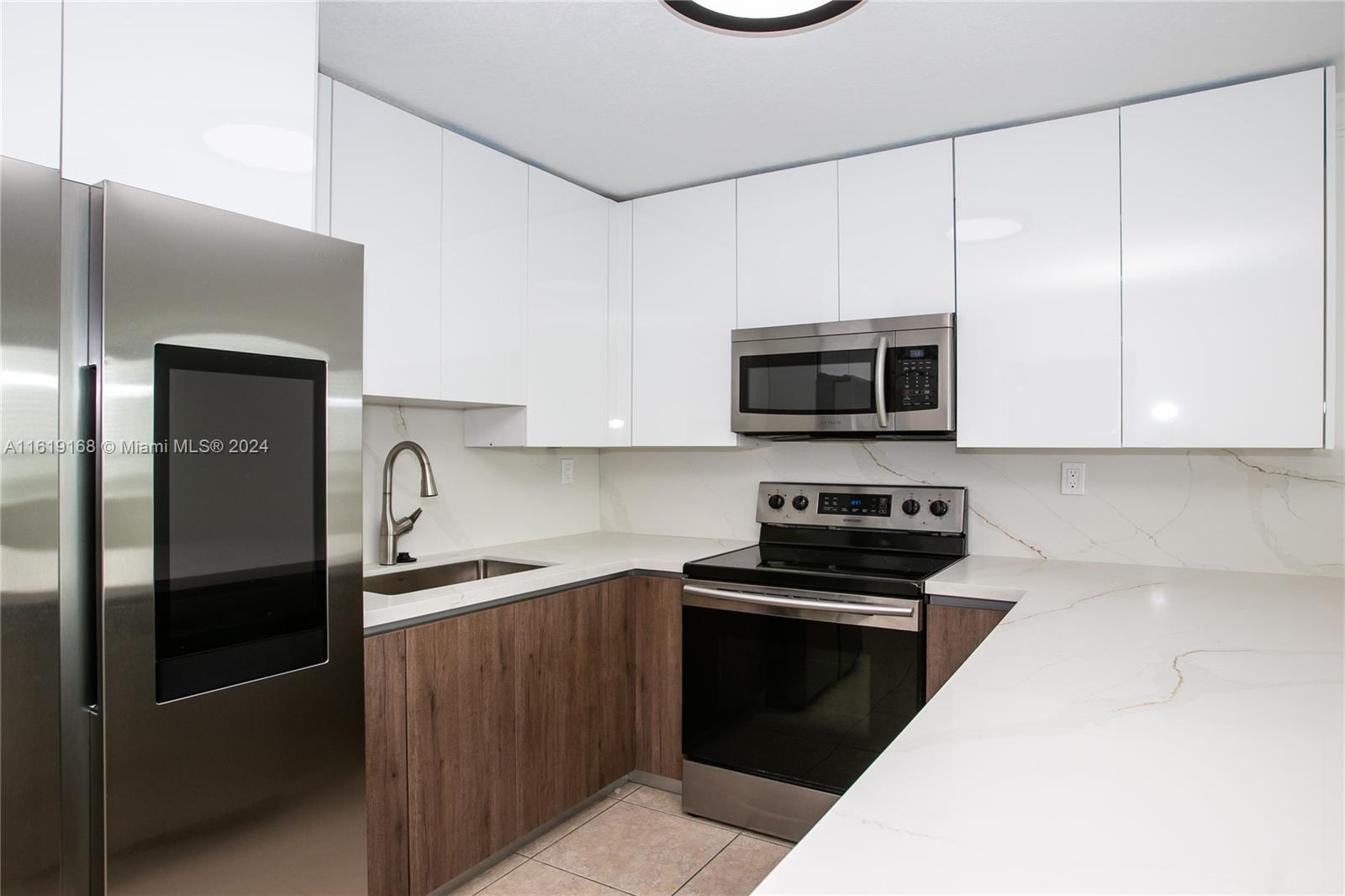 a kitchen with a sink a microwave and cabinets