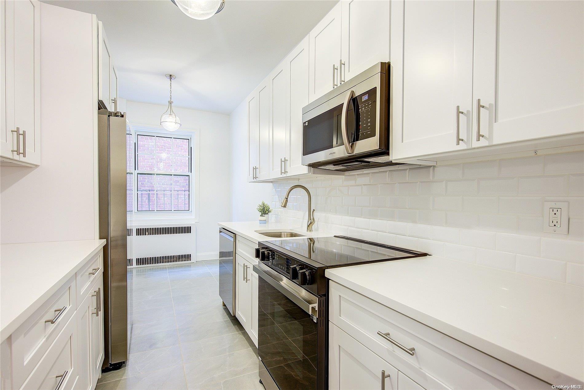 a kitchen with stainless steel appliances granite countertop a sink and a microwave