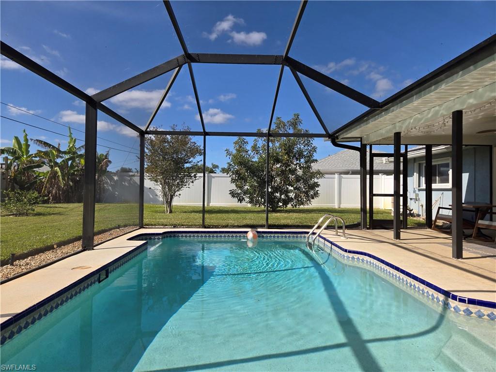 a view of a patio with a table and chairs under an umbrella