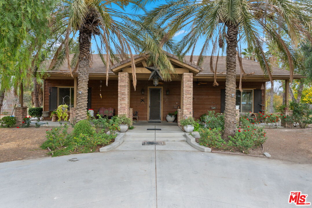 front view of a brick house with a small yard