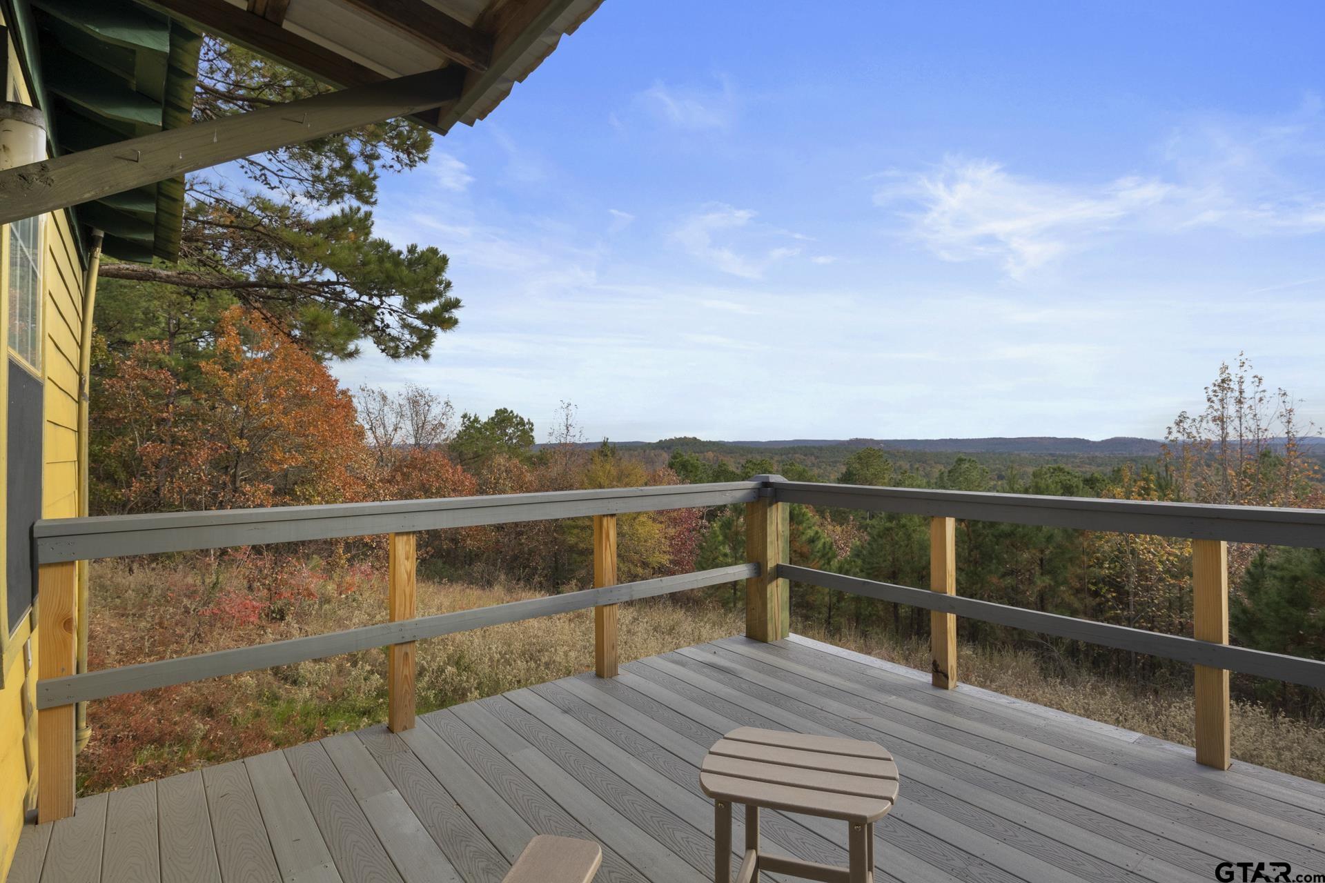 a view of a balcony with wooden floor and outdoor space