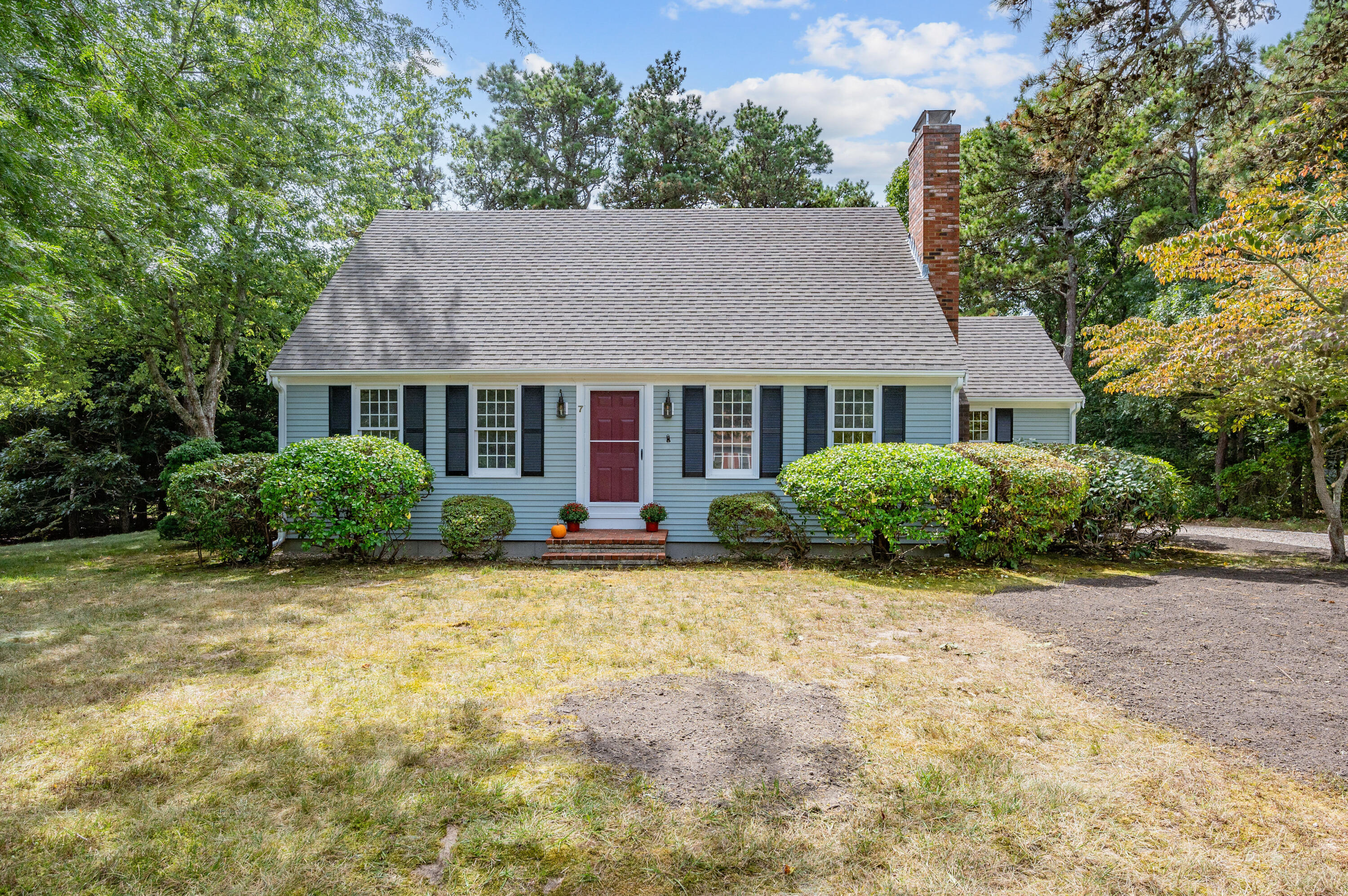 a house that has a tree in front of it