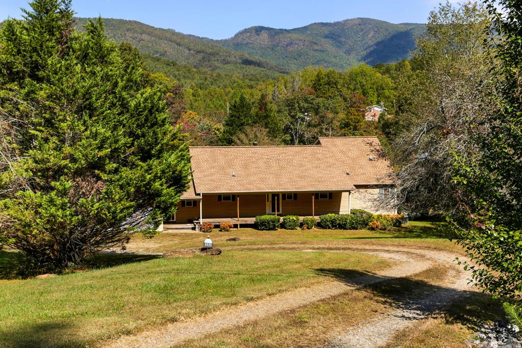 a view of house with swimming pool and mountains