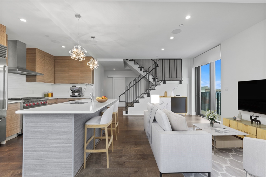 a living room with lots of furniture and kitchen view