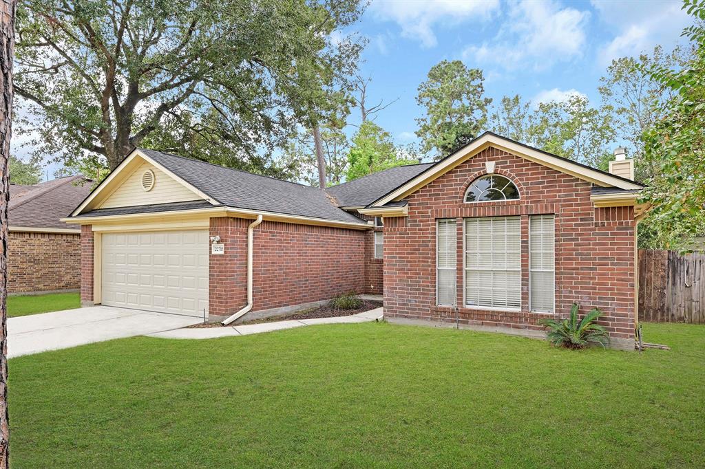 a front view of a house with a garden and yard