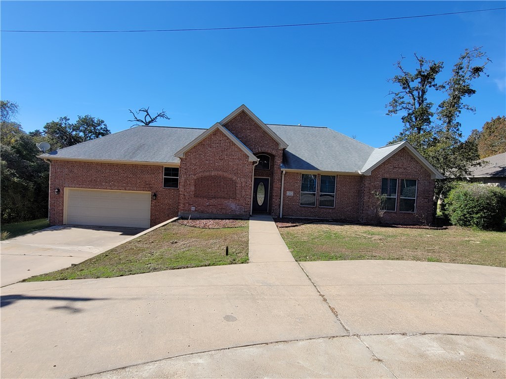 Ranch-style home featuring a front lawn