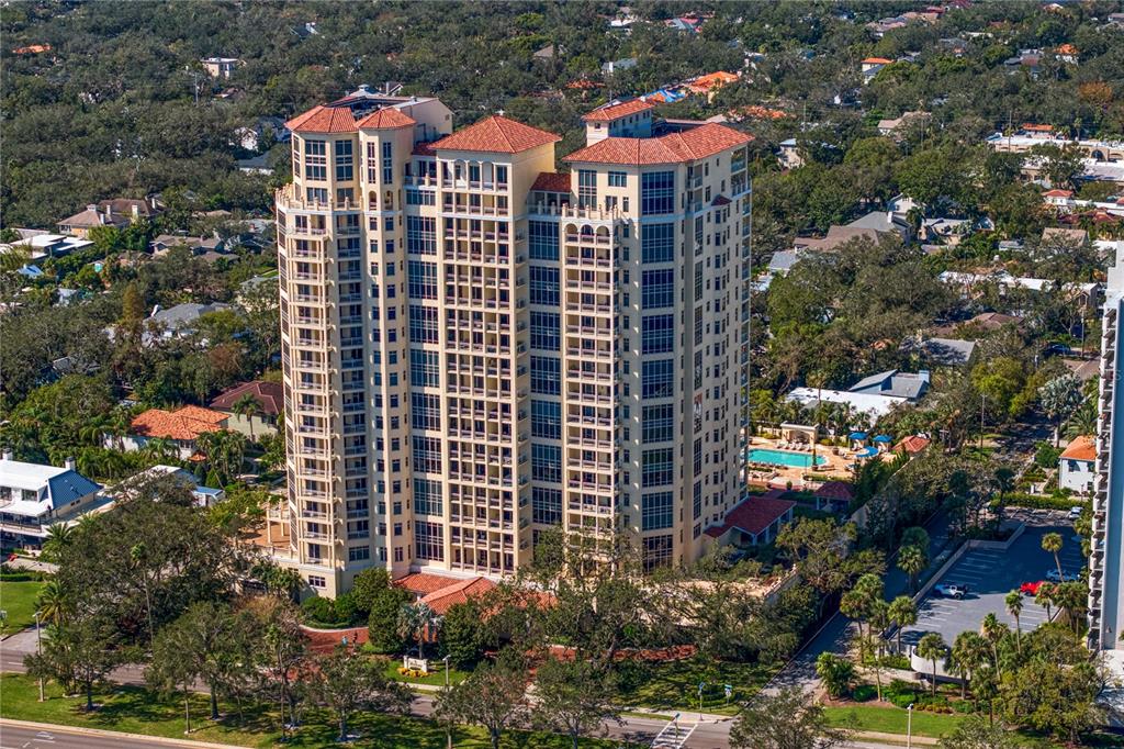 a front view of a multi story residential apartment building with a yard