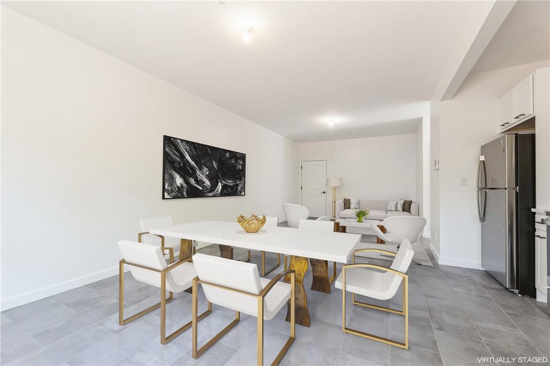 a dining room with furniture and a refrigerator