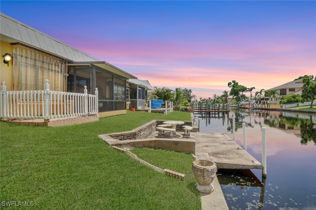 a view of house with backyard and outdoor seating