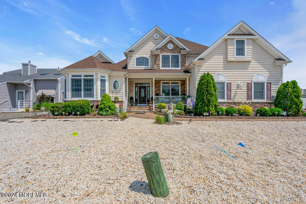 a front view of a house with porch and sitting area