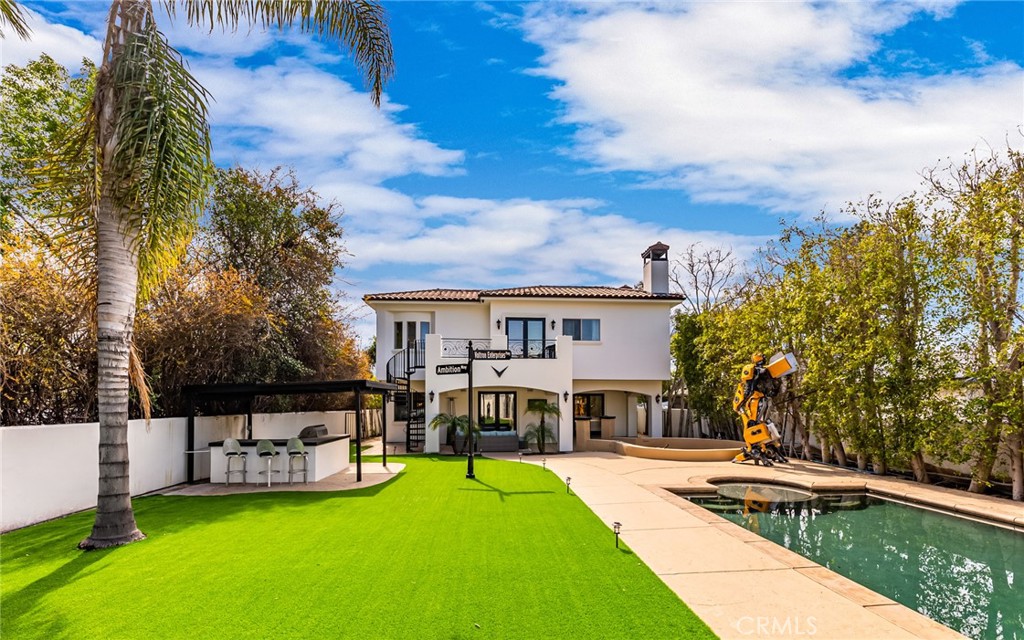 a view of a house with swimming pool and sitting area