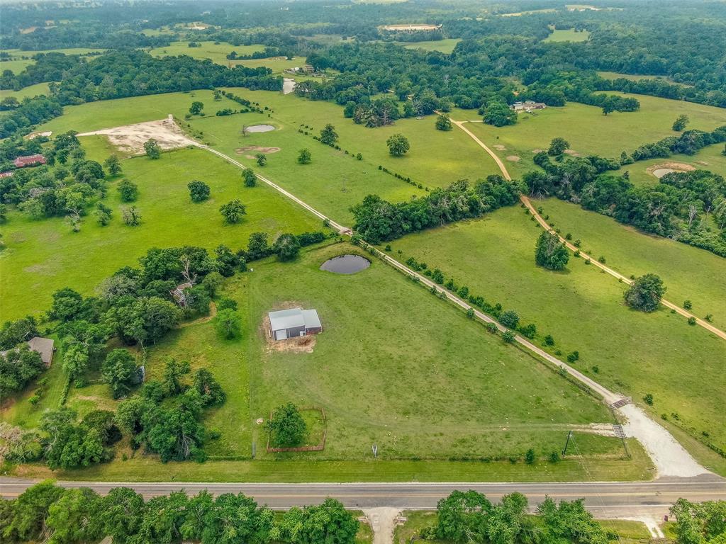 an aerial view of a residential houses with outdoor space and river