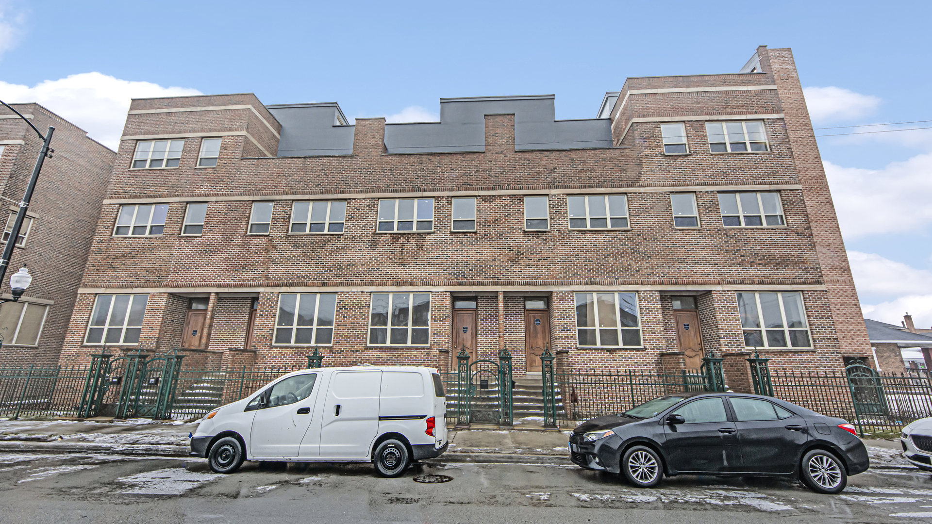 a car parked in front of a brick house