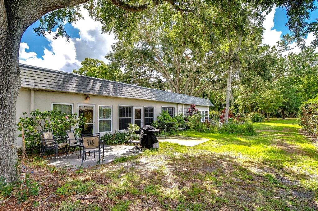 a view of a house with backyard sitting area and garden