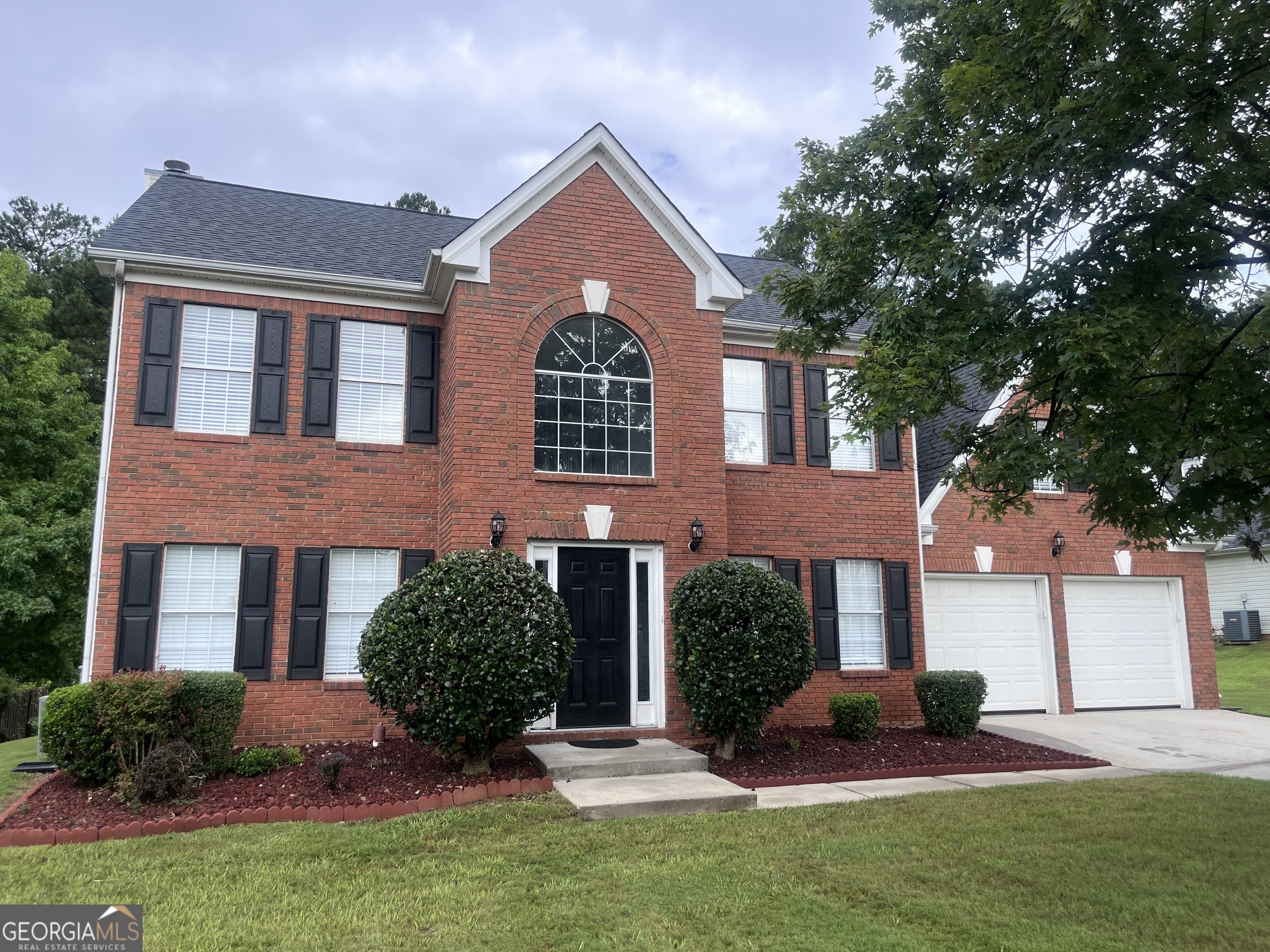 front view of a house with a yard