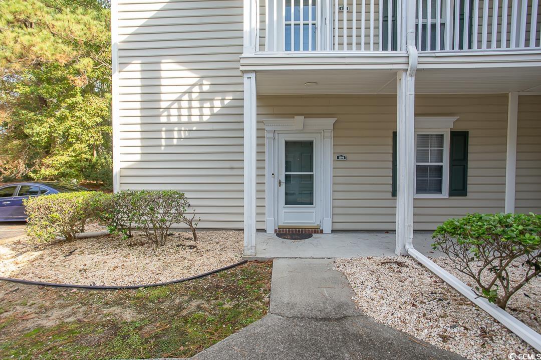 View of exterior entry featuring a balcony