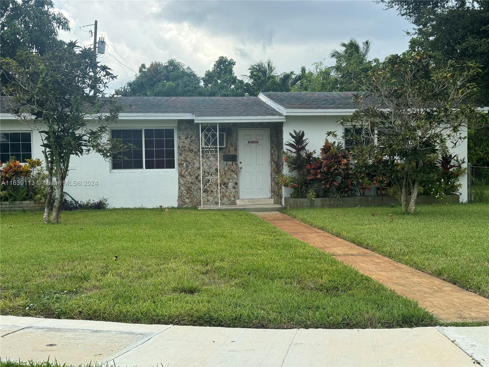 a front view of house with garden