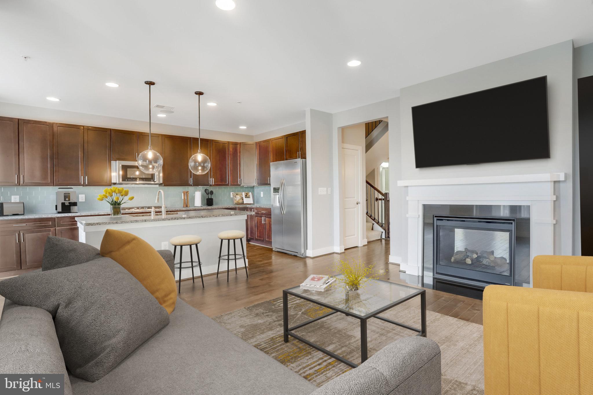 a living room with fireplace furniture and a flat screen tv