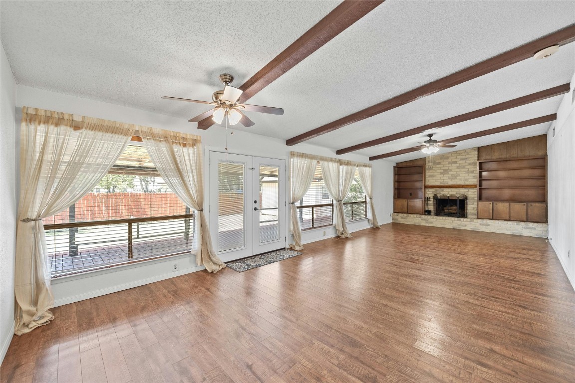 The spacious living room is set under high, beamed ceilings.