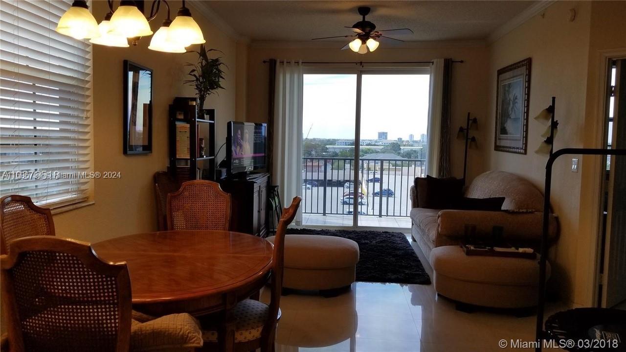 a view of a livingroom with furniture and a large window