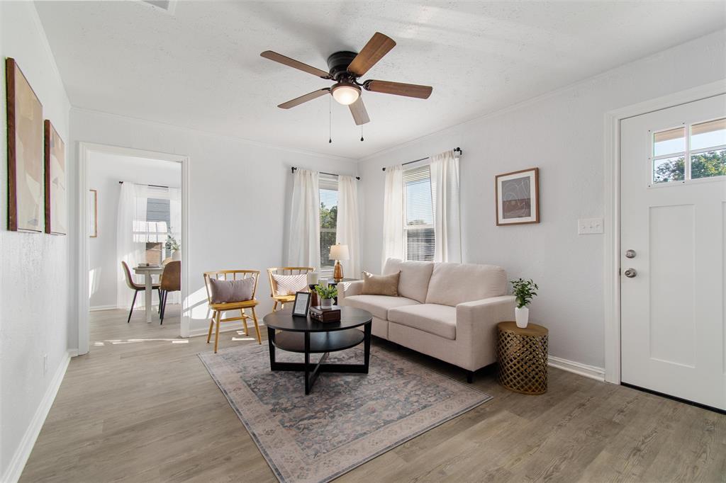 a living room with furniture and a wooden floor