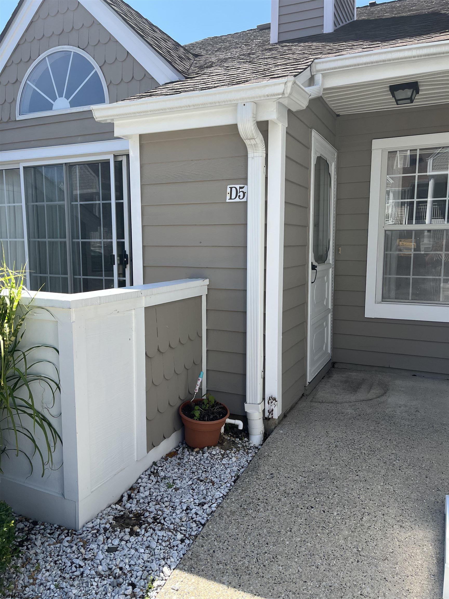 a view of a porch with a door and a window