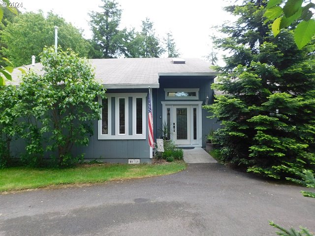 a front view of a house with a yard and outdoor seating