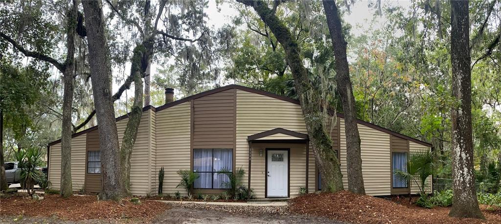 a front view of a house with trees