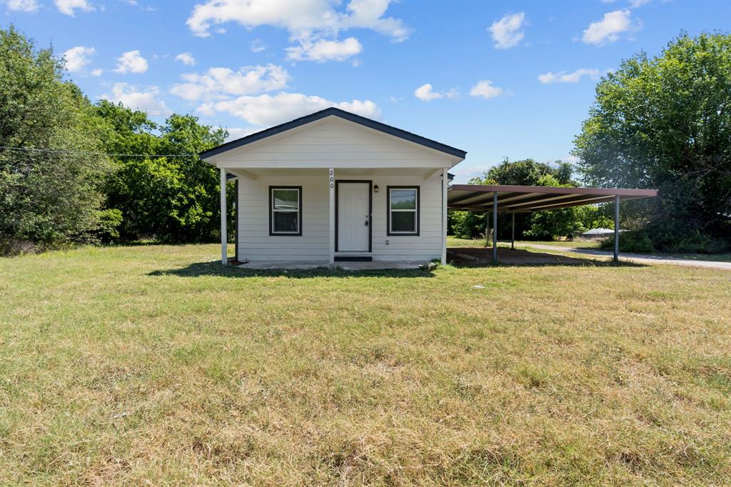 a front view of a house with yard and green space