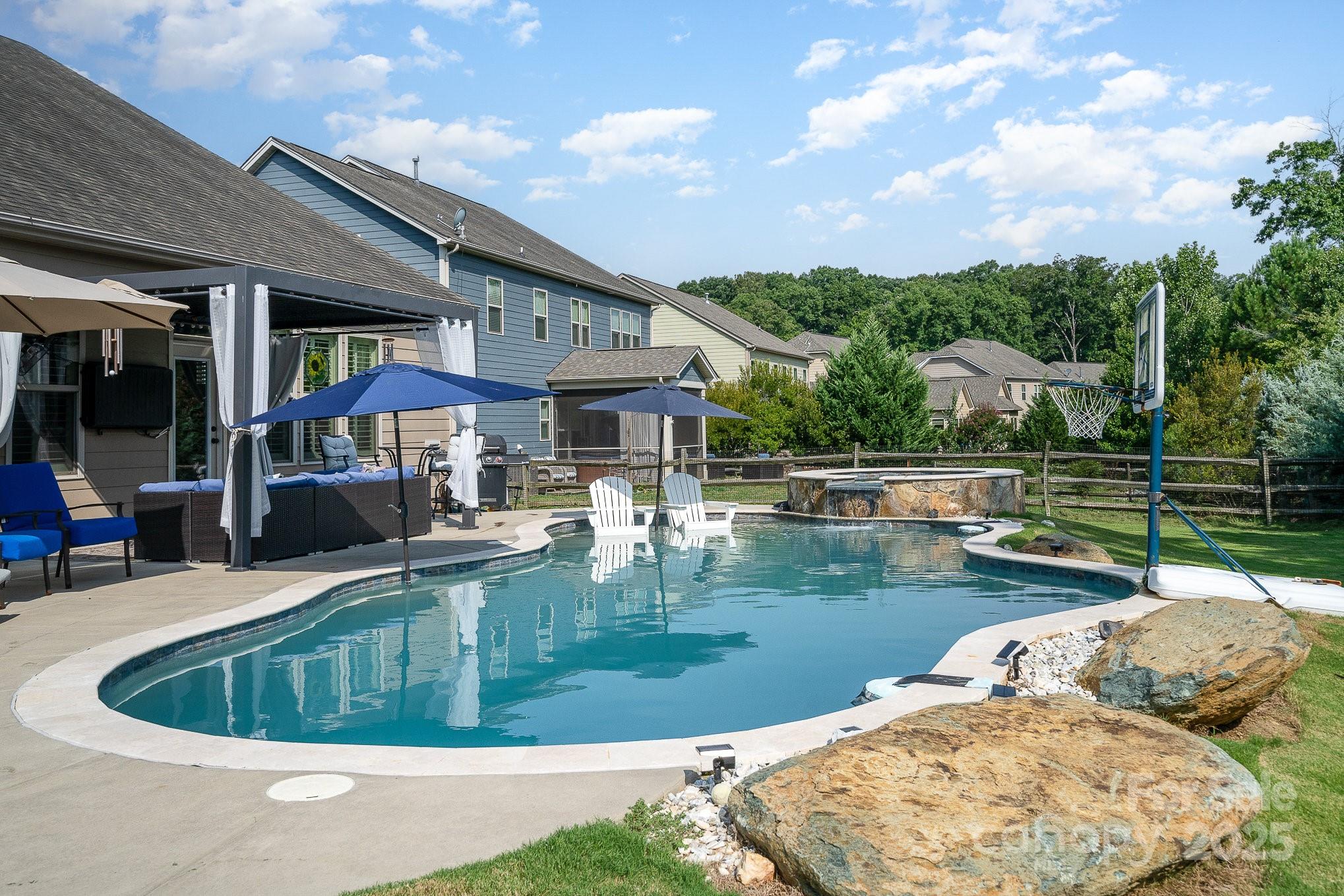 a view of a house with swimming pool and sitting area